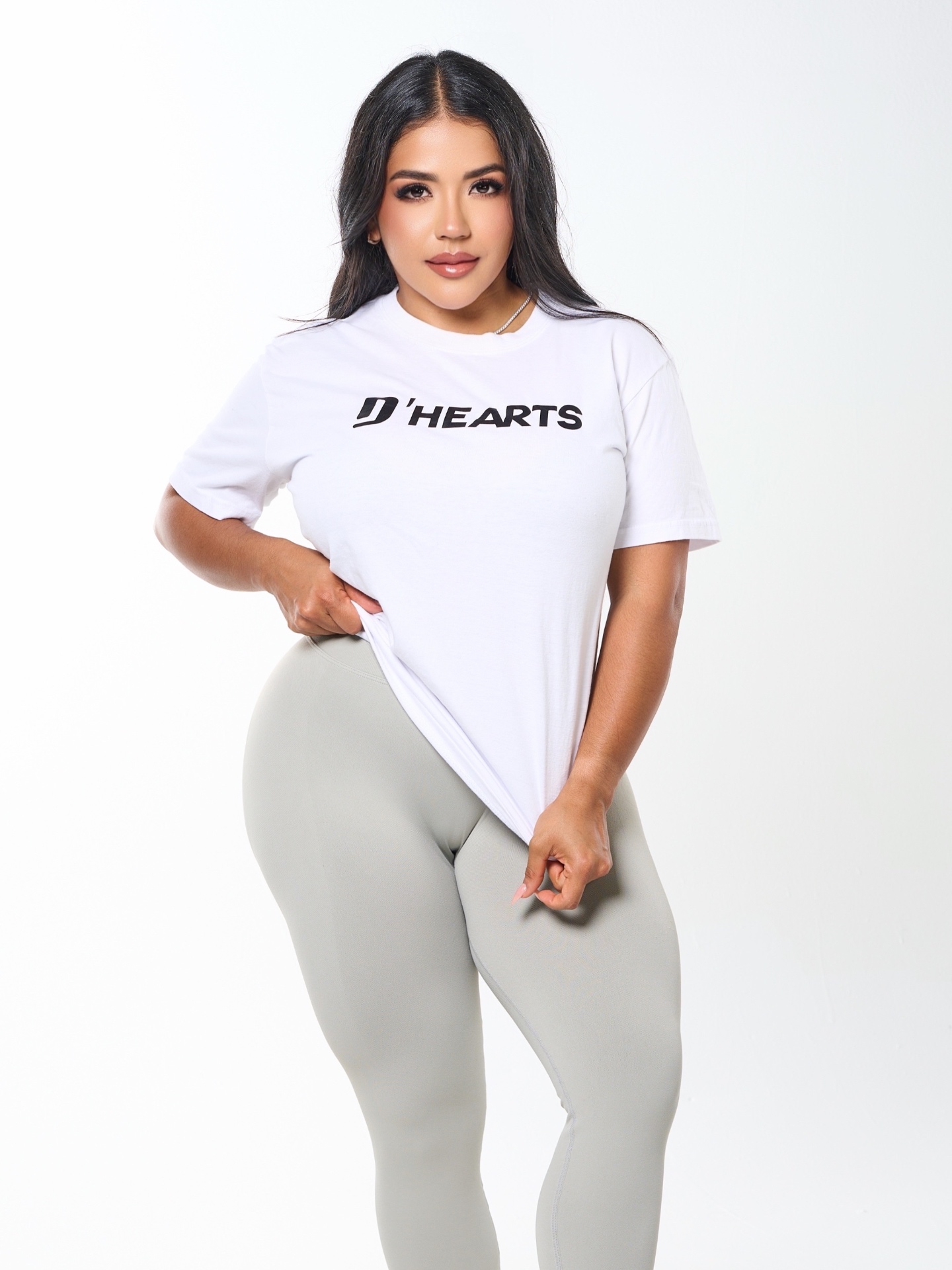 DeAngelis Puerta wearing a D'HEARTS white tee and grey sculpting leggings