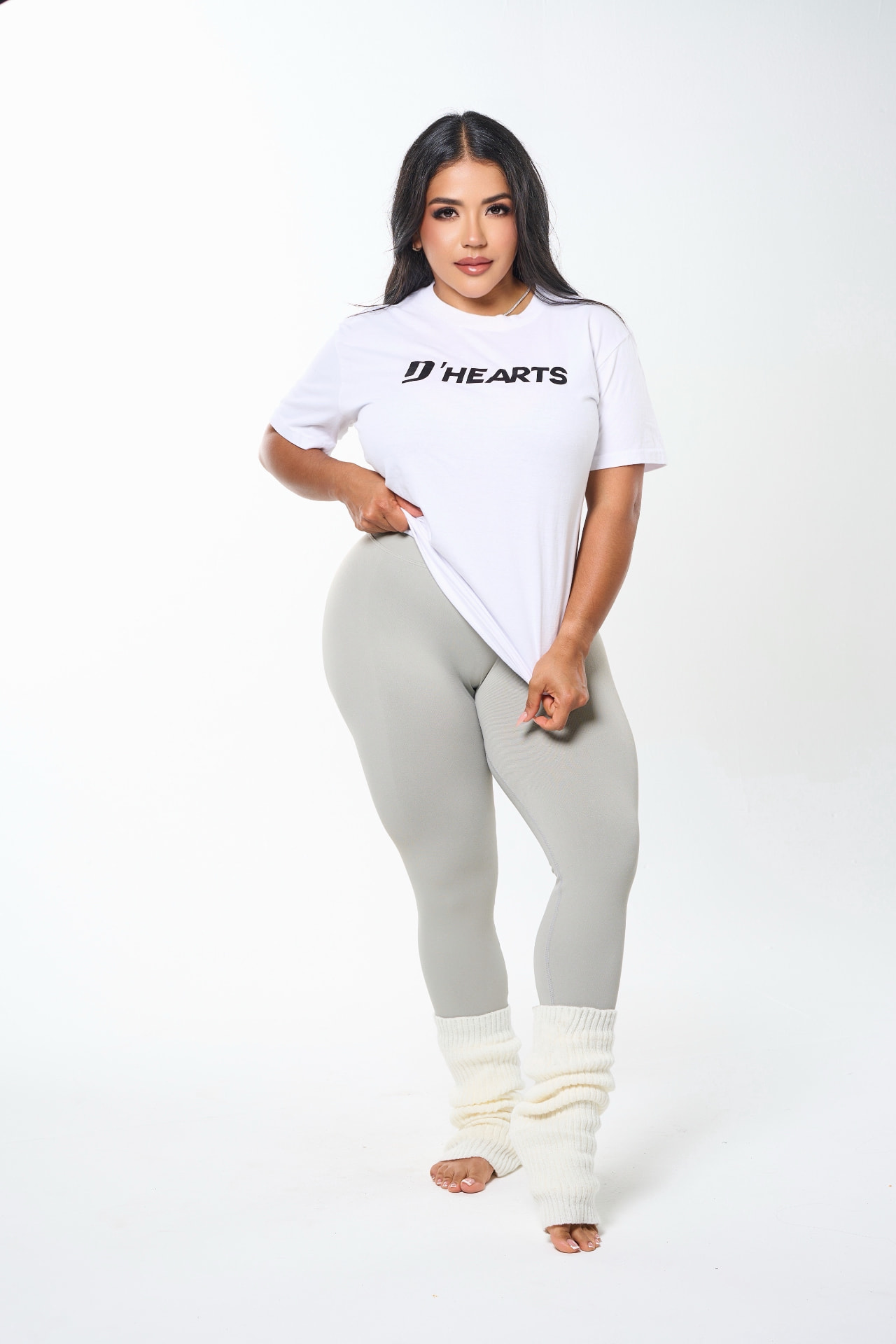 DeAngelis Puerta wearing a white D'HEARTS tee and grey sculpting leggings